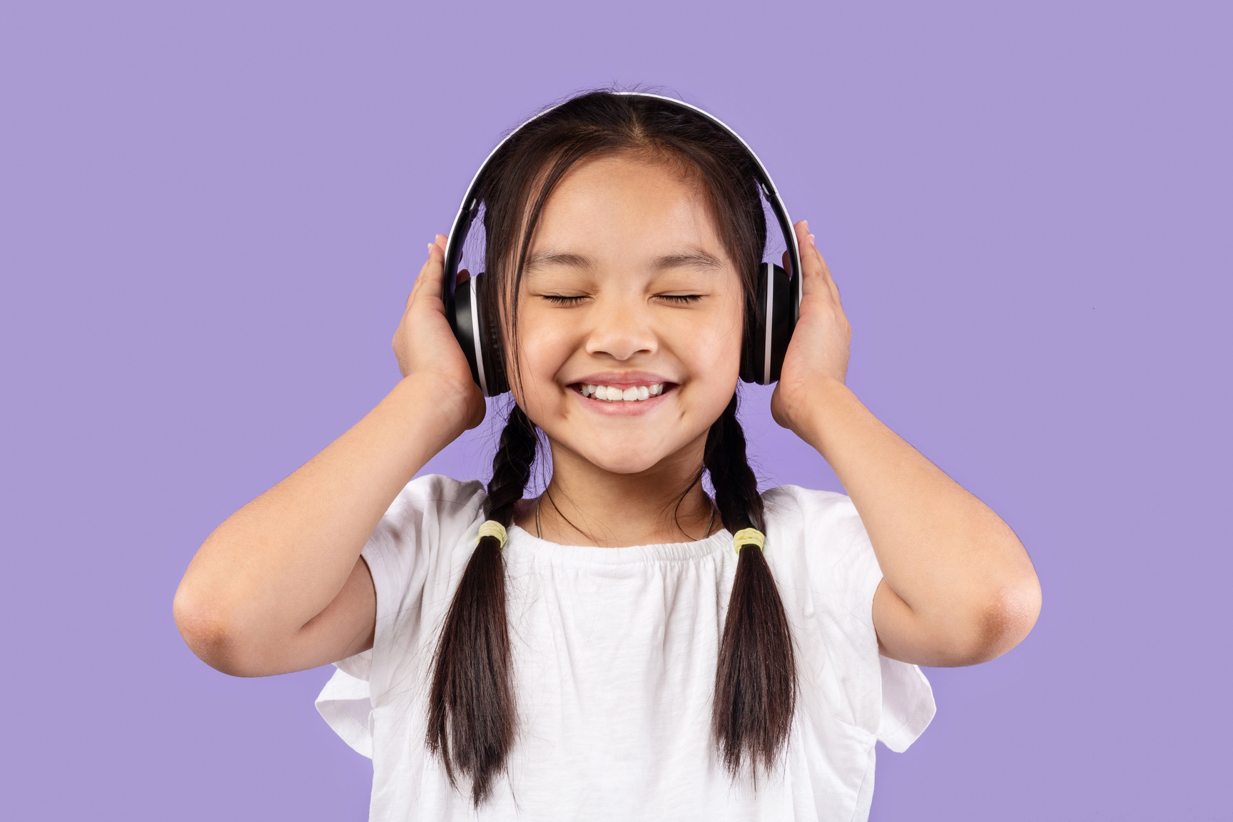 Little Korean Girl In Headphones Listening To Music, Purple Background